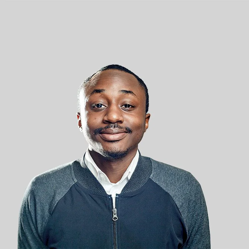 A man in a blue and white jacket smiling.
