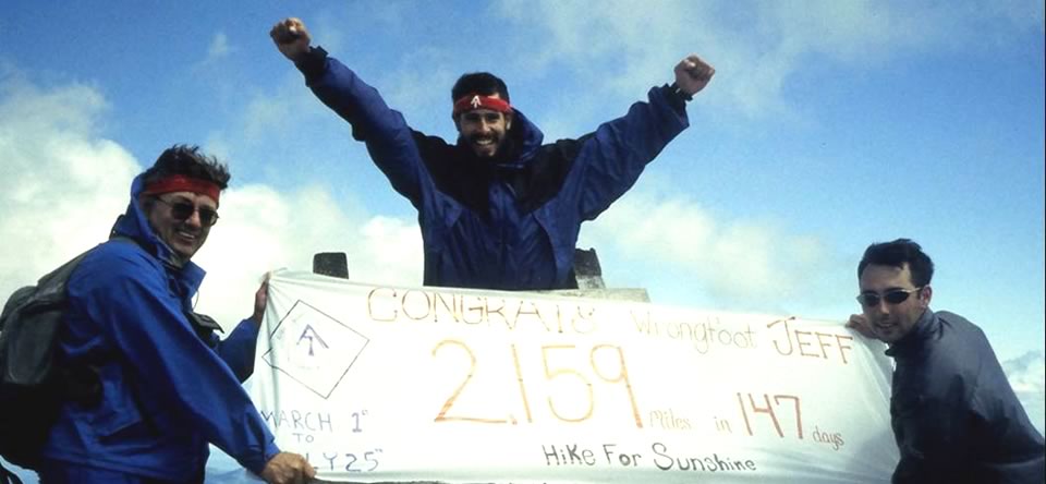 A man holding up a sign that says " congrats 2 1 5 9 ".